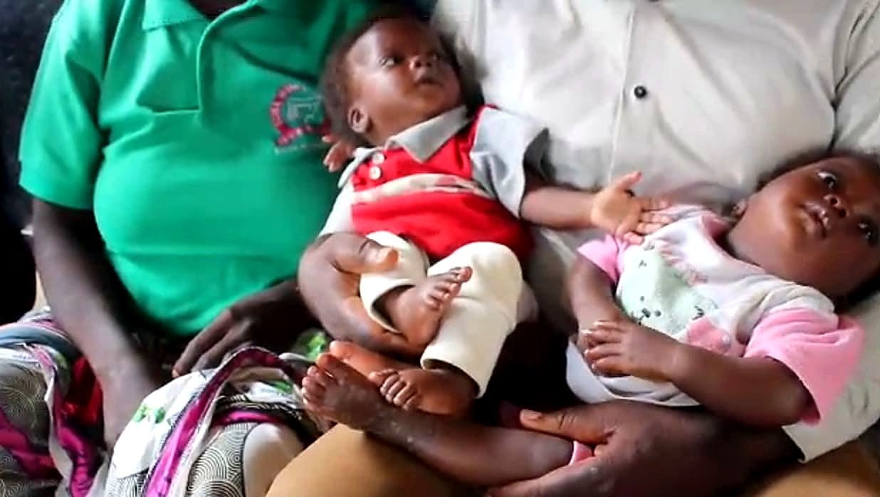 Ladidi's four-month-old twins, Miracle and Marvellous, being held